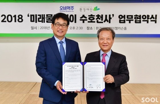 오비맥주 대외정책홍보부문 장유택 부사장(왼쪽)과 환경재단 최열 이사장(오른쪽)이 24일 서울 중구 환경재단 레이첼카슨홀에서 업무 협약을 체결한 뒤 기념촬영을 하고 있다.